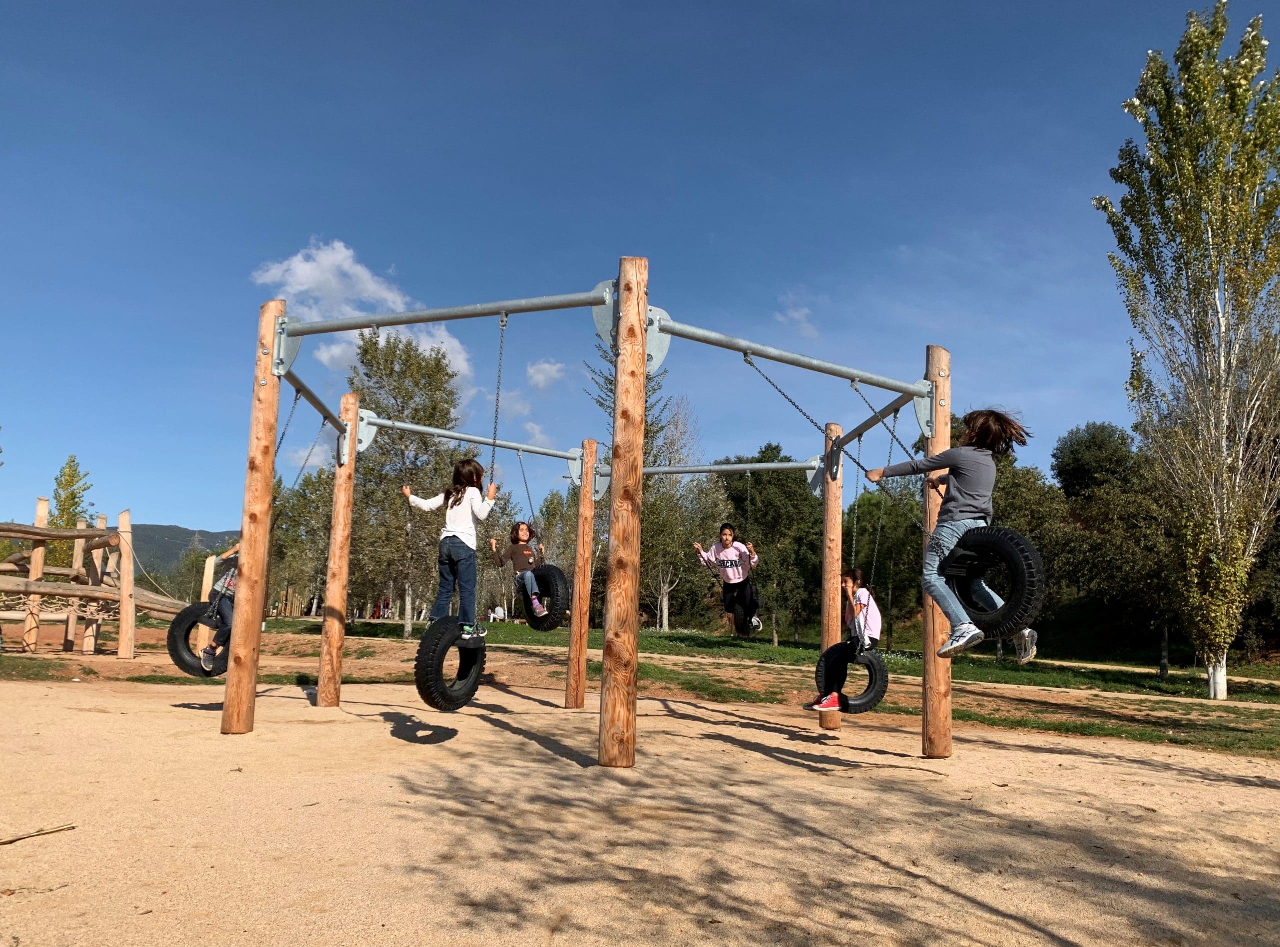 Wooden Hexagonal Swing made from large timbers and tyre seats ideal for group swinging